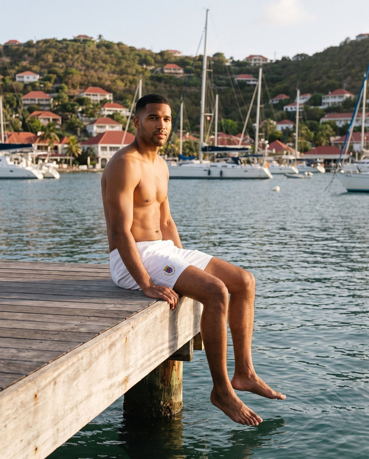 AI-generated model wearing Saint Barthélemy Men's Swim Trunks in Gustavia harbour